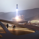 Artist’s conception of a Martian colony, with SpaceX Starship rockets in the background.